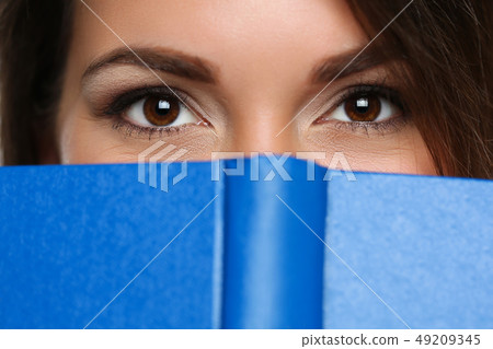 Beautiful brunette woman covering face 49209345