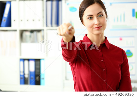 Beautiful smiling girl in red blouse pick listener from audience 49209350