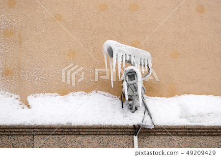 video surveillance camera on the wall with icicles video surveillance camera on the wall with icicles 49209429