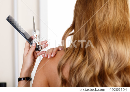 Shoulder of blonde long haired woman from behind Shoulder of blonde long haired woman from behind 49209504