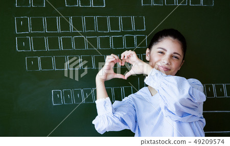 Smiling attractive young girl standing in the 49209574