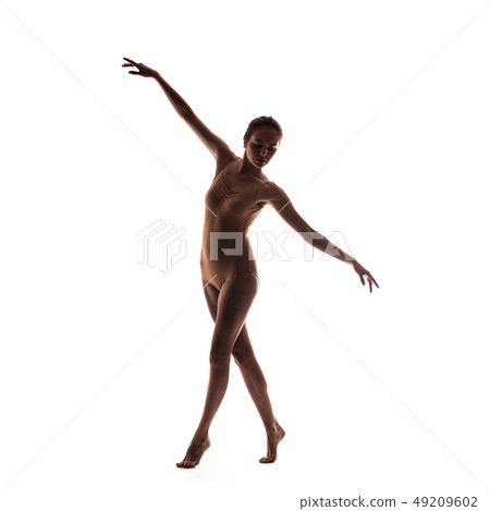 young beautiful dancer in beige swimsuit posing 49209602