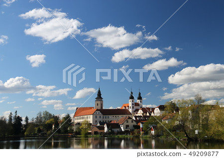 Czech Telc landscape with blue sky, clouds and church Czech Telc landscape with blue sky, clouds and church 49209877