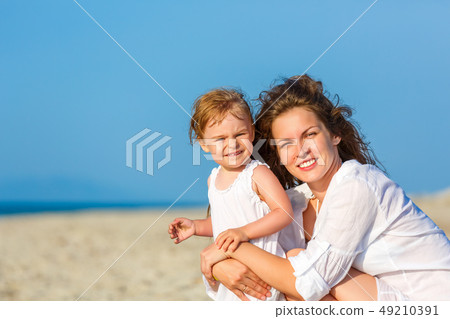 Mother and daughter on the beach Mother and daughter on the beach 49210391