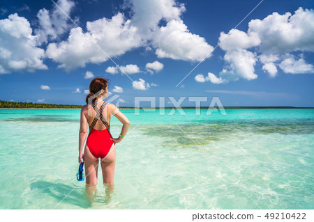 Young woman on the beautiful ocean beach in Dominican Republic Young woman on the beautiful ocean beach in Dominican Republic 49210422