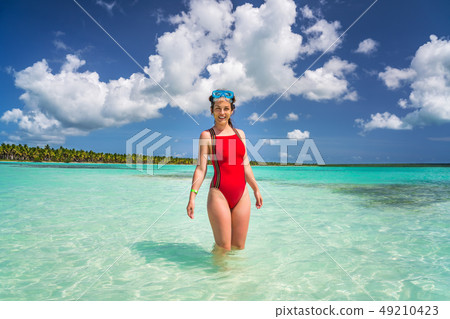 Young woman on the beautiful ocean beach in Dominican Republic Young woman on the beautiful ocean beach in Dominican Republic 49210423