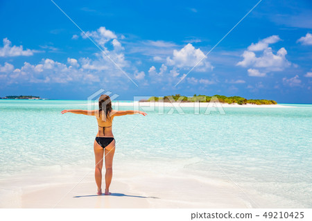 Young woman on the ocean beach Young woman on the ocean beach 49210425