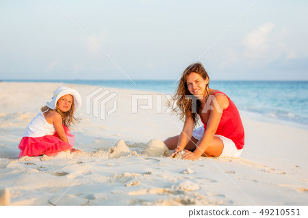 Mother and little daughter playing on the beach on Maldives at summer vacation 49210551
