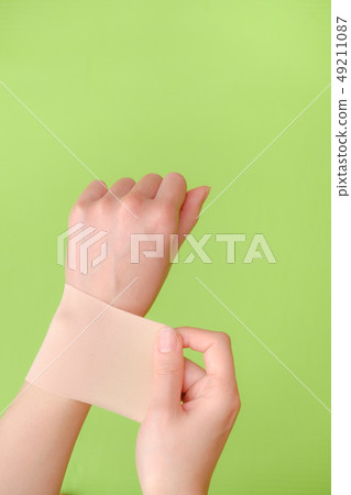 Stock Photo: hand putting a wet paste 49211087