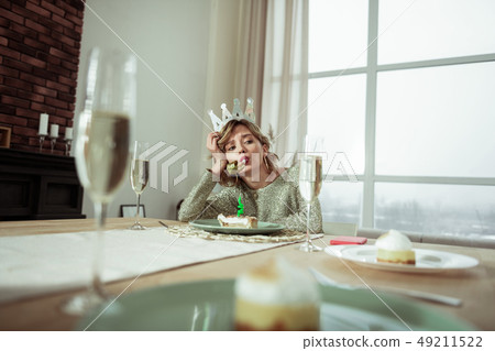 Woman wearing queen crown on birthday feeling lonely Woman wearing queen crown on birthday feeling lonely 49211522