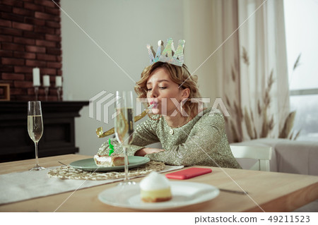 Lonely birthday woman sitting and looking at the piece of cake Lonely birthday woman sitting and looking at the piece of cake 49211523