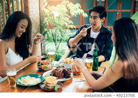 Asian people cheering beer at restaurant happy 49213708