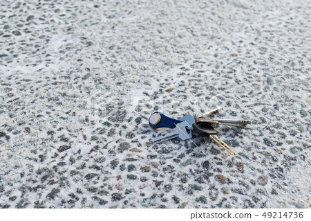 a bunch of keys lying on the asphalt road a bunch of keys lying on the asphalt road 49214736