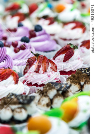 cupcake cakes with fresh berries on the counter  49216871