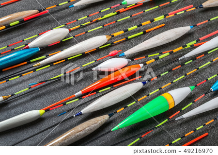 many fishing floats made of balsa, peacock feathers and wood 49216970