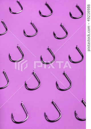 lots of fishing hooks on purple background 49216986