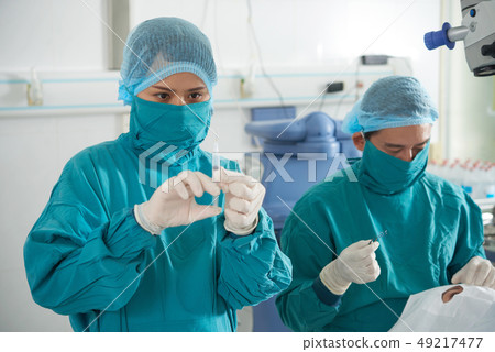 Surgeons making operation on eyes Surgeons making operation on eyes 49217477