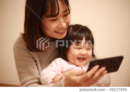 Parent and child using smartphone Parent and child using smartphone 49217859