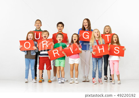Our rights. Group of children with red banners isolated in white Our rights. Group of children with red banners isolated in white 49220192