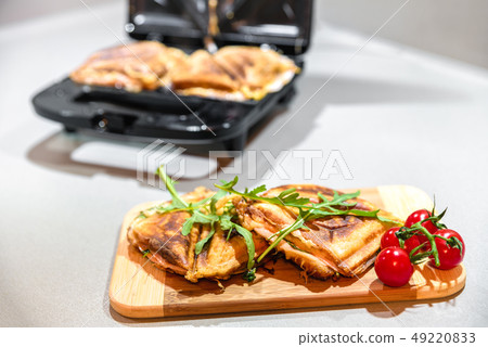 Open black sandwich toaster in kitchen Open black sandwich toaster in kitchen 49220833