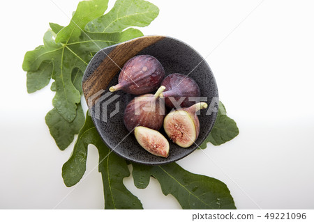 figs in a a bowl with fig leaf 49221096