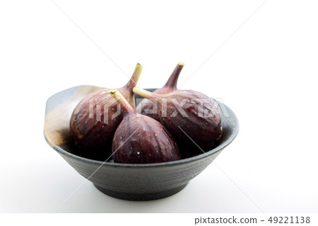 Organic figs in a bowl on white table Organic figs in a bowl on white table 49221138