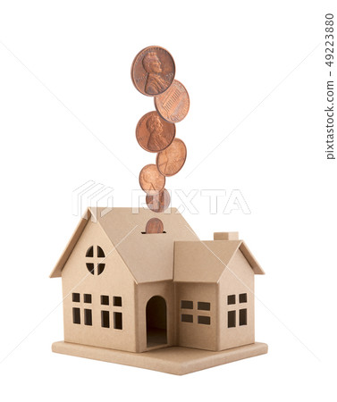 Cardboard house with coins falling into the slot 49223880