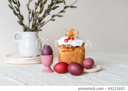 Easter cake and painted eggs. Easter composition with orthodox sweet bread, kulich and eggs on light 49223881