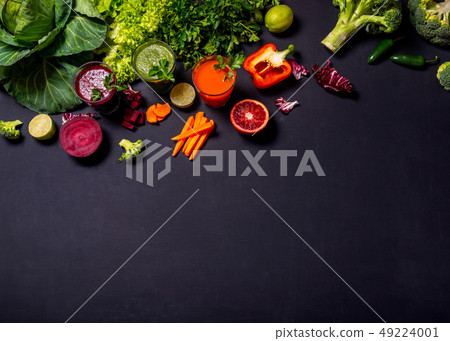 Different healthy vegan drinks with fruits and vegetables on the black wooden background. Flat lay 49224001