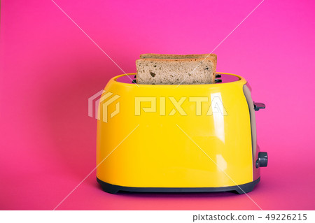 yellow toaster on a pink background 49226215