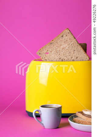 yellow toaster on a pink background 49226276