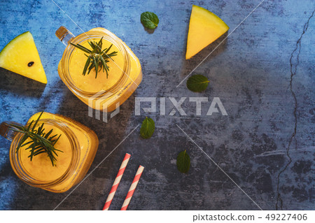 Yellow watermelon drink in glasses with mint.  49227406