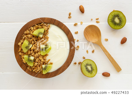 Top view of yogurt in a wooden bowl and mint Top view of yogurt in a wooden bowl and mint 49227433