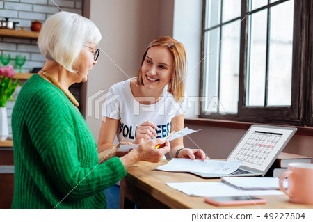 Retired dame looking at loan payment date on laptop calendar 49227804