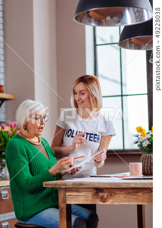 Graceful aging woman looking surprisingly at document form 49228038