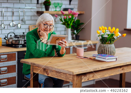 Joyful madam delighting in relatives portrait spending time at kitchen 49228162