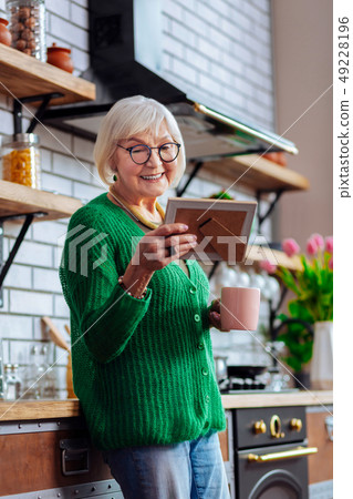 Charming granny feasting eyes with grandchildren picture in frame 49228196