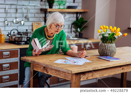 Attractive concerned dame in years doing vedic charts with pencil 49228879