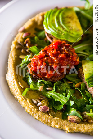 Hummus with avocado and capers 49229506
