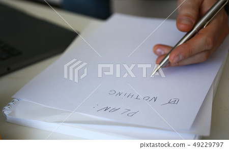 Male hand hold silver pen composing to do list 49229797