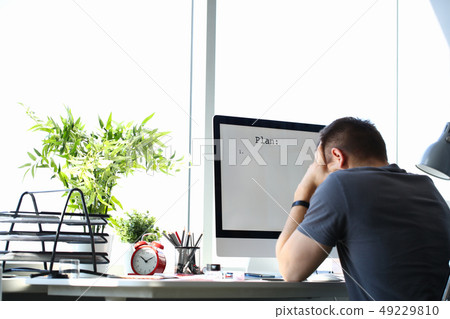 Sad upset male worker hold his head solving business problem 49229810