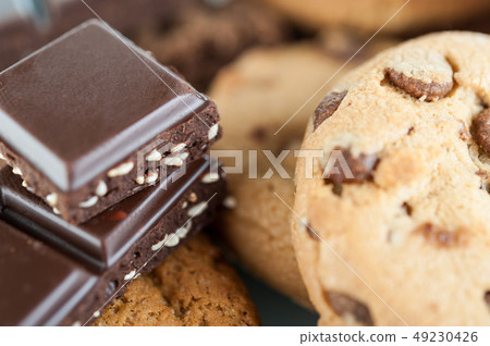 Various shortbread, oat cookies, chocolate chip biscuit and pieces of chocolate with seeds and nuts. 49230426