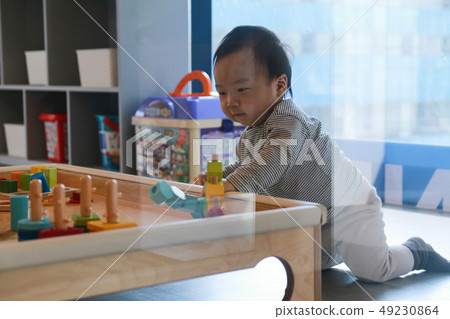 A boy playing a figure-matching game A boy playing a figure-matching game 49230864