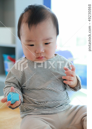 A boy playing a figure-matching game 49230868