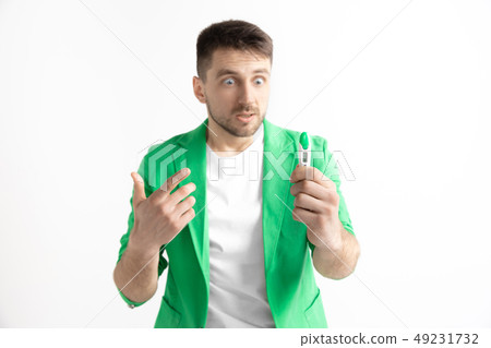 Upset man looking in pregnancy test. Frustrated model Upset man looking in pregnancy test. Frustrated model 49231732