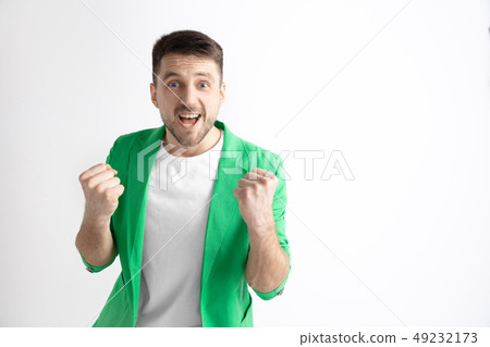 Winning success man happy ecstatic celebrating being a winner. Dynamic energetic image of male model Winning success man happy ecstatic celebrating being a winner. Dynamic energetic image of male model 49232173