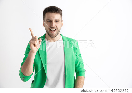 The happy businessman standing and smiling against gray background. The happy businessman standing and smiling against gray background. 49232212