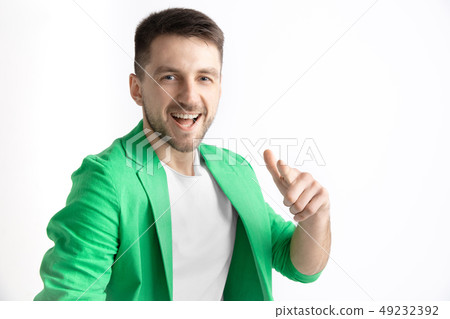 The happy businessman standing and smiling against gray background. The happy businessman standing and smiling against gray background. 49232392