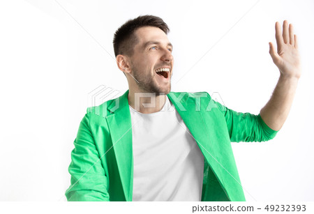 The happy businessman standing and smiling against gray background. The happy businessman standing and smiling against gray background. 49232393