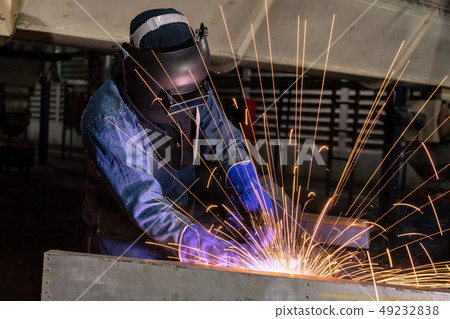 Industrial worker is welding in factory Industrial worker is welding in factory 49232838